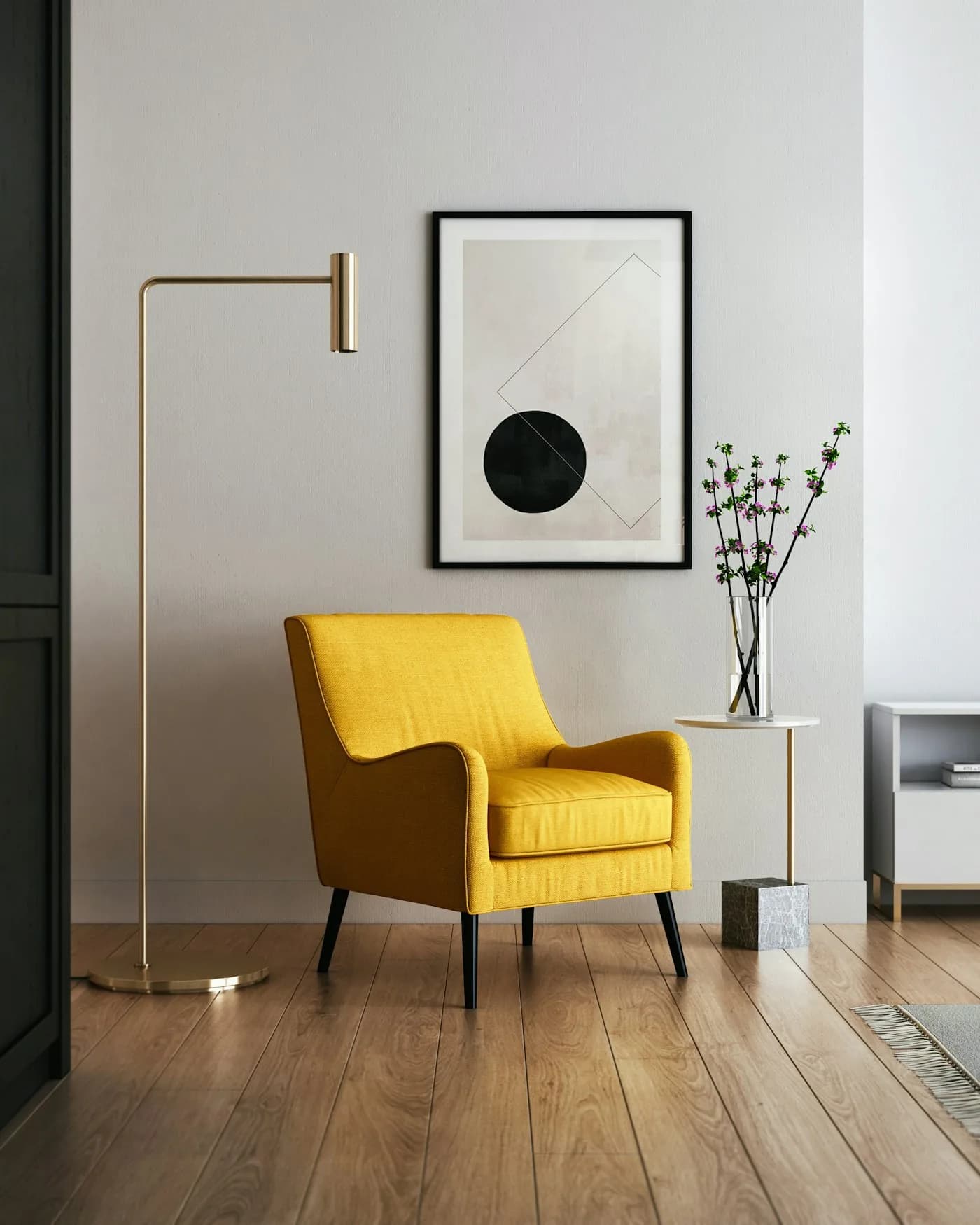 A yellow lounge chair and brass floor lamp in a calm, sunlit room